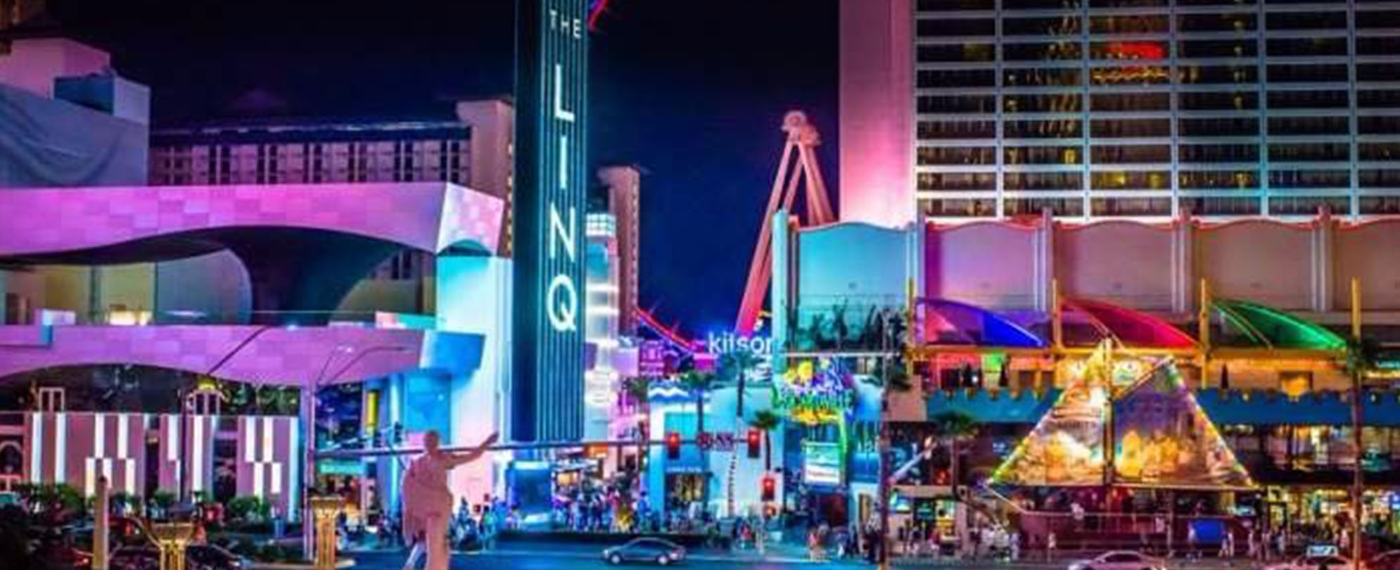 The LINQ Hotel and tourist attractions lit up at night on the Las Vegas Strip.