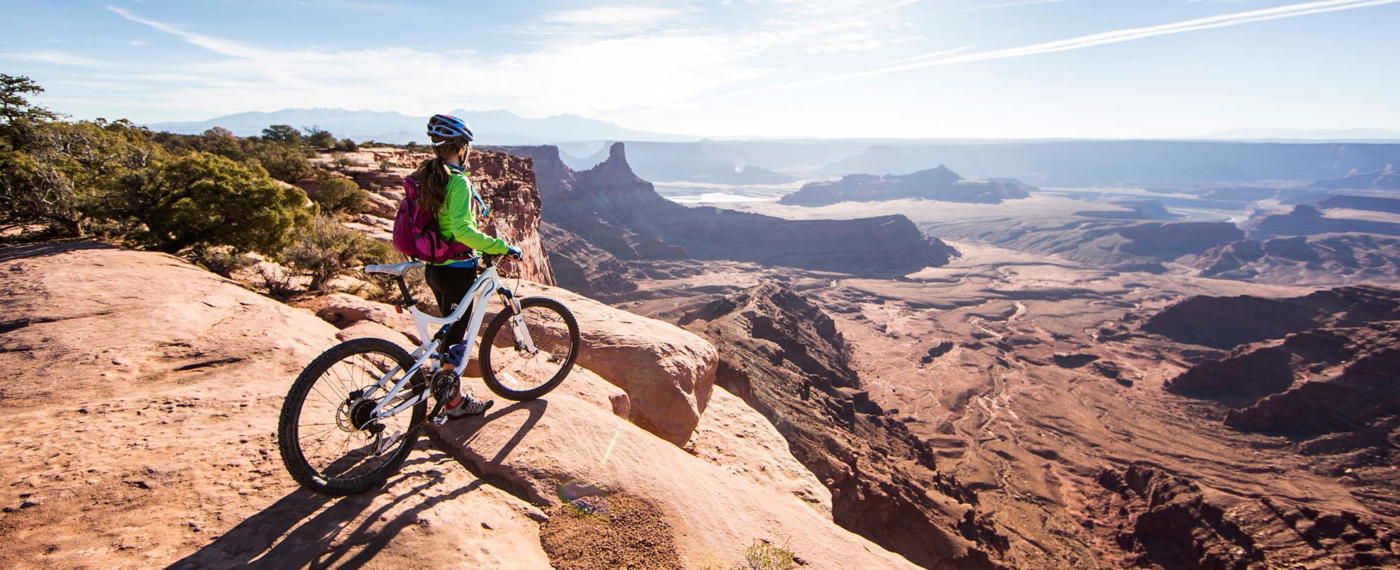 A mountain biker stopped on top of a mountainside in Moab, Utah.